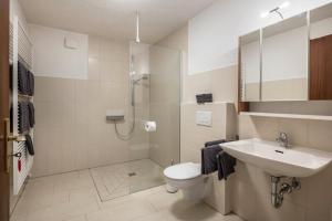 a bathroom with a toilet and a sink and a shower at Haus Isele in Urberg +18 photos