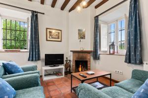 a living room with two couches and a fireplace at La Braña in Bustio