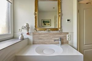 a bathroom with a sink and a mirror at Amrum in Galmsbüll +19 photos