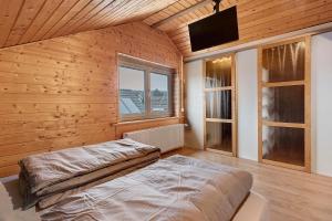a bedroom with a bed in a room with wooden walls at Ferienwohnung Witt in Salem