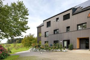 a building with a lot of windows on it at Ferienappartements Bayer in Sigmarszell