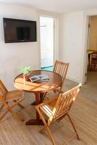 a wooden table and chairs in a living room at Downtown Historic Nantucket Cottage in Nantucket