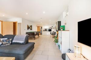 a living room with a couch and a flat screen tv at Eifel im Herzen in Hambuch