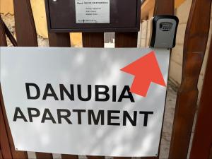 a sign that reads danuja appointment with a red arrow at Danubia Apartment Gabčíkovo in Gabčíkovo