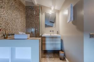 a bathroom with a sink and a mirror at Maison Sainte-Maxime avec jardin in Le Plan +19 photos