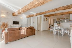 a living room with a couch and a table at Maison Sainte-Maxime avec jardin in Le Plan