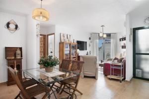 a living room with a glass table and chairs at Bella Vistas in Zahara de los Atunes