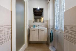 a bathroom with a sink and a mirror at Prima Del Cielo -Appartamento Monti in Esino Lario +27 photos