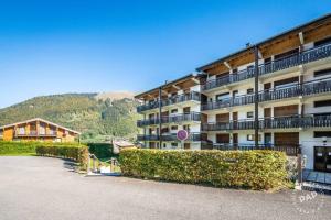 a large apartment building with bushes in front of it at Apt Morzine 1000 in Morzine +3 photos