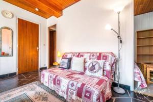 a bedroom with a bed and a lamp in a room at Apt Morzine 1000 in Morzine