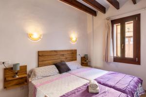 a bedroom with a large bed and a window at Casa Magui in Capdepera +18 photos