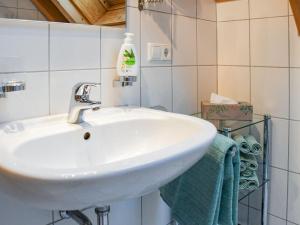 a bathroom with a white sink and green towels at Stulzenhof in Hofstetten +19 photos