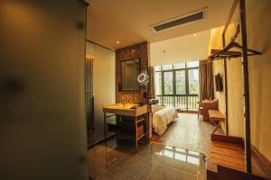 a bathroom with a sink and a bed and a mirror at James Joyce Hotel Zhuhai Hengqin Chimelong in Zhuhai
