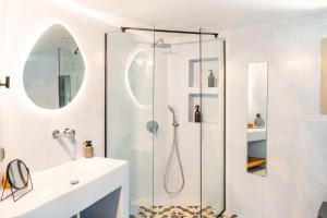 a bathroom with a shower and a sink at Black Tower Villa in Apollonia +23 photos