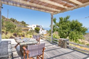 a patio with a table and chairs and a view of the ocean at Black Tower Villa in Apollonia