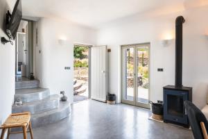 a living room with stairs and a fireplace at Black Tower Villa in Apollonia