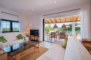 a living room with two white couches and a table at Can Joan Durban in Sant Joan de Labritja