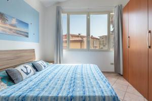 a bedroom with a large bed with two pillows at Casa Vacanze 4 Venti in Muravera