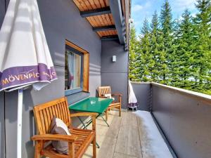 a balcony with a table and chairs and an umbrella at Apartment Naviser Hütte-3 by Interhome in Navis +57 photos