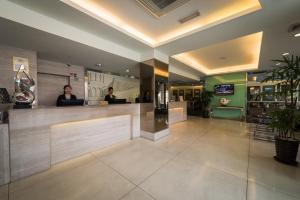 a lobby with two people standing at a counter at Hotel Sentral Georgetown @ City Centre in George Town