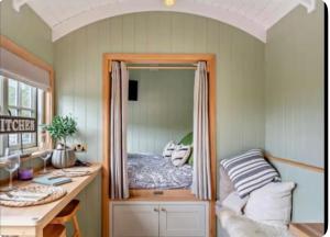 a small bedroom with a bed in a mirror at Farm view hall in Harrogate