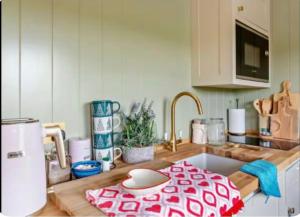 a kitchen with a sink with a red and white towel at Farm view hall in Harrogate