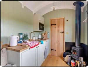 a small kitchen with a stove in a room at Farm view hall in Harrogate