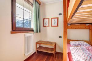 a bedroom with a bunk bed and a window at Residence Larice Bianco App n2 in Campodolcino