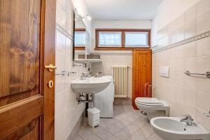 a bathroom with a sink and a toilet at Residence Larice Bianco App n2 in Campodolcino +17 photos