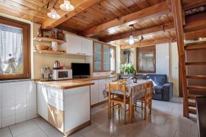a kitchen with a table and a dining room at Eun Tchì Vo - Gignod in Gignod