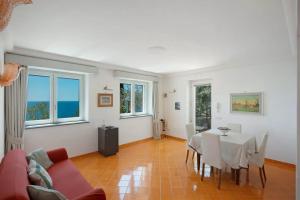 a living room with a table and a couch at Luxury Villa Seaview con jacuzzi in Conca dei Marini