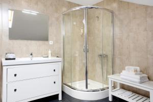 a bathroom with a shower with a sink and a toilet at Casa da Olides - Studio in Santana +16 photos