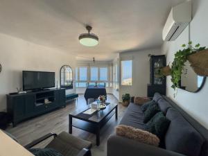a living room with a couch and a tv at Apartamento vistas playa Torrox A73 in Torrox