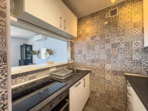 a kitchen with a sink and a mirror at Apartamento vistas playa Torrox A73 in Torrox