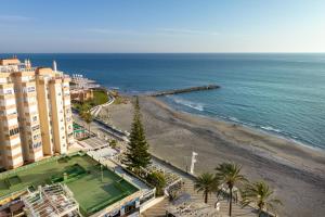 a view of a beach with a building and the ocean at Apartamento vistas playa Torrox A73 in Torrox