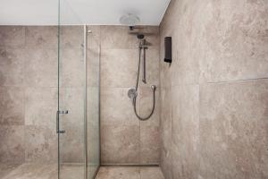 a bathroom with a shower with a glass door at Ferienapartments Ariana in Bad Säckingen +65 photos