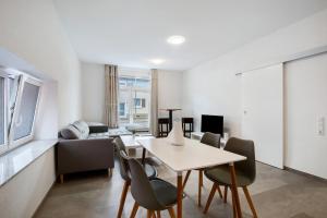 a living room with a table and chairs at Ferienapartments Ariana in Bad Säckingen