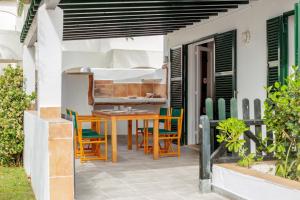 a patio with a table and chairs and a bed at Son Xoriguer 14 in Son Xoriguer