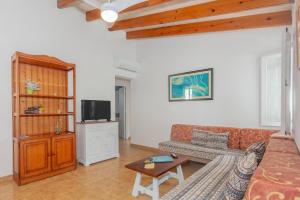 a living room with a couch and a tv at Son Xoriguer 14 in Son Xoriguer