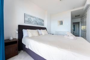 a bedroom with a large bed with white sheets at Mi Capricho Calahonda in Mijas +23 photos