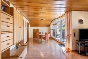 a kitchen and dining room with a table and a television at Ferienwohnung Urban in Bestwig +22 photos