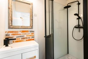 a bathroom with a shower and a sink and a mirror at Villa la forge expérience bien-être in Nuaillé-dʼAunis +33 photos
