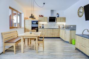 a kitchen with a wooden table and a table and chairs at Ferienwohnung Schachen in Garmisch-Partenkirchen