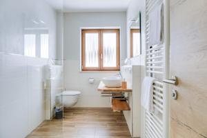 a bathroom with a sink and a toilet at Ferienwohnung Schachen in Garmisch-Partenkirchen +16 photos