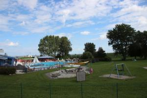 a park with a swimming pool and a playground at Ferienhaus Strandnest Dangast in Dangast