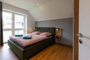 a bedroom with a bed with a large window at Ferienhaus Strandnest Dangast in Dangast