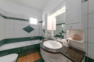 a bathroom with a sink and a toilet and a tub at Villa Melenia 2 in Agia Pelagia