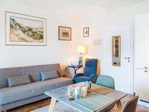 a living room with a couch and a table at Apartment Leonard Lake by Interhome in Ghiffa