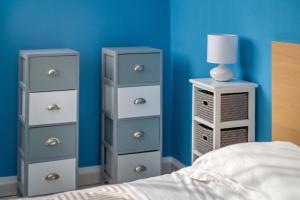 a bedroom with three dressers and a bed with a lamp at Studio a Nice in Nice