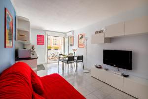 a living room with a red couch and a television at Studio a Nice in Nice